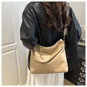 Detail of cream tote bag with stylish patterned wide shoulder strap and oil wax leather texture