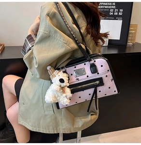 Pink polka dot canvas tote with black leather strap and a cute white teddy bear charm