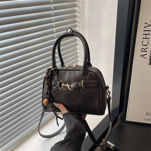 Dark coffee Boston style handbag with gold hardware and woven bell charm accent