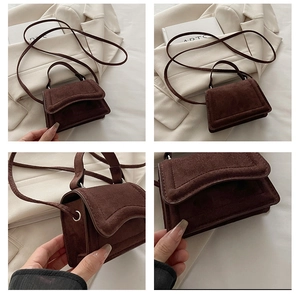 Detail view of dark brown faux suede mini bag with matte texture and fine stitching