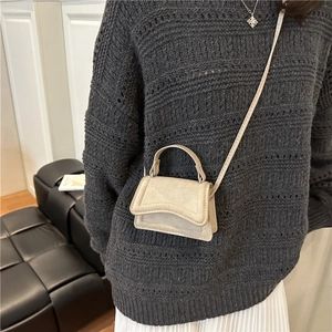 Minimalist beige suede small square crossbody bag with curved flap and top handle