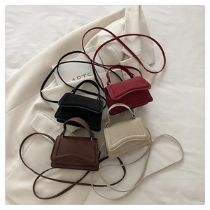 Detailed display of four mini flap handbags in black, burgundy, brown, and beige colors