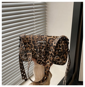 Detail of leopard print punk handbag with silver studs and metal grommet decorations