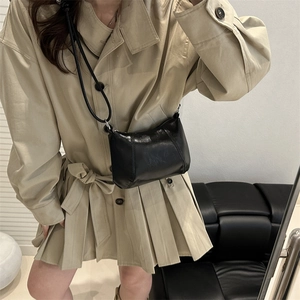 Chic black polished leather crossbody bag with stylish stitching for seasonal fashion