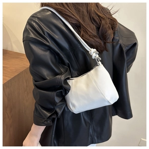 Détail du sac hobo blanc montrant la bandoulière nouée et la texture du cuir lisse
