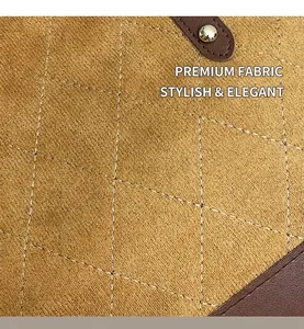 Gros plan sur la texture en cuir matelassé avec coutures vintage et détails de rivets dorés