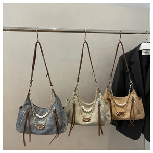 Detailed view of vintage tote bags with pearl chains and stylish side tassel zippers