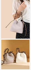 Detail of woven bucket bag with thick chain handle and drawstring in various colors
