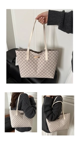 Detail of off-white tote bag featuring brown M-letter texture and gold logo plaque