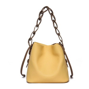 Chic yellow lychee grain leather bucket bag with unique dark brown braided handle