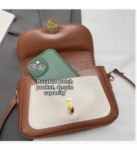 Detail showing the inner storage space and a durable front pocket on a brown crossbody bag