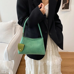 Chic light green matte suede shoulder bag with leaf charm for a minimalist trendy look