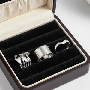Three-piece silver stainless steel ring set featuring wide beaded and fluid open designs