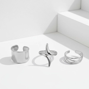 Three-piece silver stainless steel chunky open ring set on minimalist white display