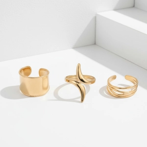Detailed view of three gold-plated chunky open rings with minimalist textured designs