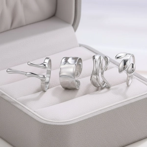 Set of four irregular stainless steel rings with hammer texture and wave designs
