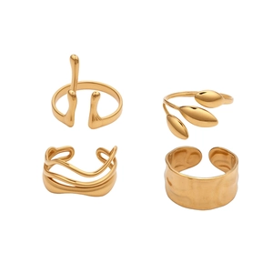 Set of 4 irregular golden stainless steel rings including hammered and leaf designs