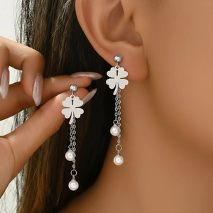 Silver stainless steel four-leaf clover tassel earrings with white pearls on a model
