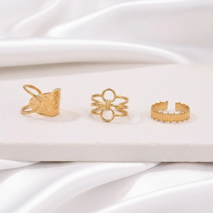 Detailed view of three gold geometric rings with textured hammered and layered patterns