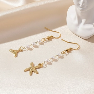Gold starfish and mermaid tail drop earrings with white pearls on elegant satin