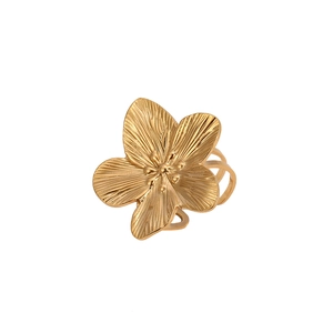 Detailed close-up of a matte gold flower ring featuring textured petals and stamens