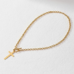 Gold stainless steel cross pendant necklace with toggle clasp on a white background