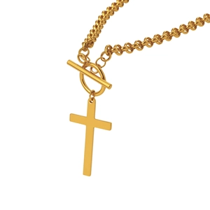 Detail of gold cross pendant on a thick link chain with a unique decorative OT clasp