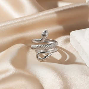 Adjustable silver stainless steel snake ring with detailed scale texture on silk background