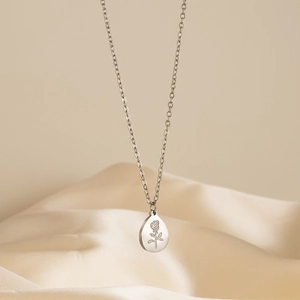 Silver stainless steel oval rose flower pendant necklace on beige silk background