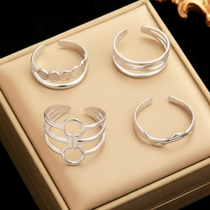 Set of four minimalist silver-tone open rings with geometric cutout designs