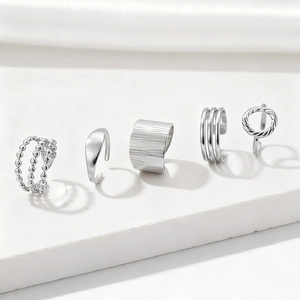 Five-piece minimalist silver stackable ring set with geometric hollow and textured designs
