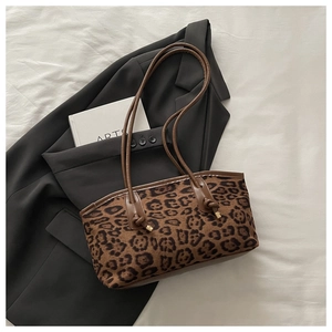 Detail of leopard print tote bag with brown faux suede texture and slim shoulder straps