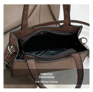 Détail du sac cabas en daim marron avec fermeture éclair sécurisée et intérieur spacieux