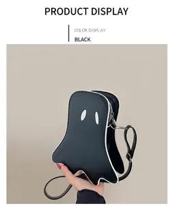 Detail view of the black ghost-shaped shoulder bag with white piping and silver zipper