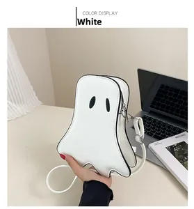 Close-up of ghost-shaped white leather crossbody bag with black embroidered eyes