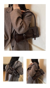Detailed view of dark brown glossy leather shoulder bag with decorative silver buckles