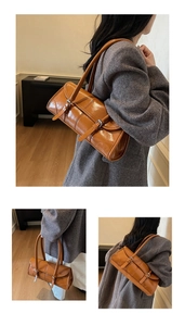 Detailed views of caramel brown leather shoulder bag with vintage silver metal buckles