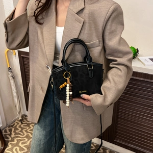 Retro black leopard bucket bag with wooden bead pendant and elegant crossbody strap