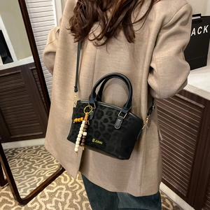 Fashionable leopard print tote bag for women with tassel charm in urban street style