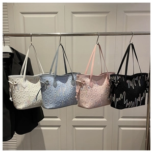 Detail shot of four colorful tote bags with textured patterns and pulse-style stitching