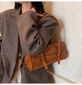Brown oil wax leather underarm bag shown on model with vintage office style outfit