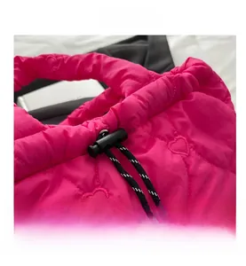 Detail of pink quilted tote bag with heart patterns and woven drawstring closure