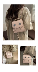 Detail view of pink vintage small backpack with star hardware and dual strap options