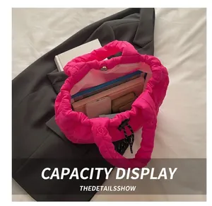 Internal view of a pink quilted tote bag showing large capacity for daily items