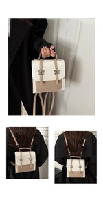 Detail of cream and brown star backpack shown held by hand and worn on shoulders