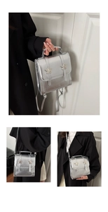 Detail of silver metallic star buckle and adjustable strap on a trendy mini backpack