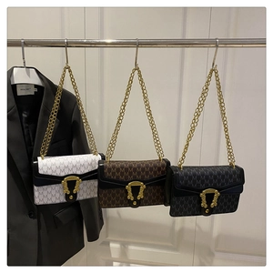 Three checkerboard letter crossbody bags with vintage gold buckles on blazer background