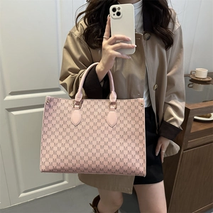 Pink monogram tote bag with repeating M-pattern and stylish leather top handles for women