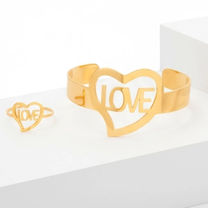 Golden stainless steel LOVE heart open ring and bangle set on white geometric stands