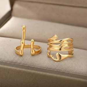 Minimalist 18K gold plated lava rings set with irregular flowing texture in jewelry box
